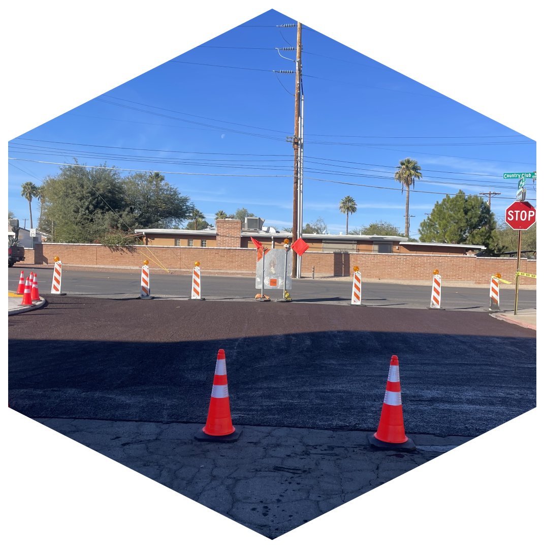 A couple of orange cones sitting in the middle of an empty parking lot.